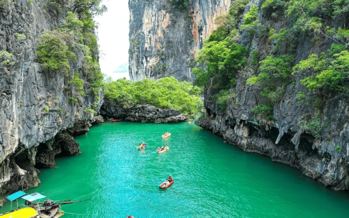 A speedboat crossing the bay from Phuket towards the limestone cliffs of Krabi