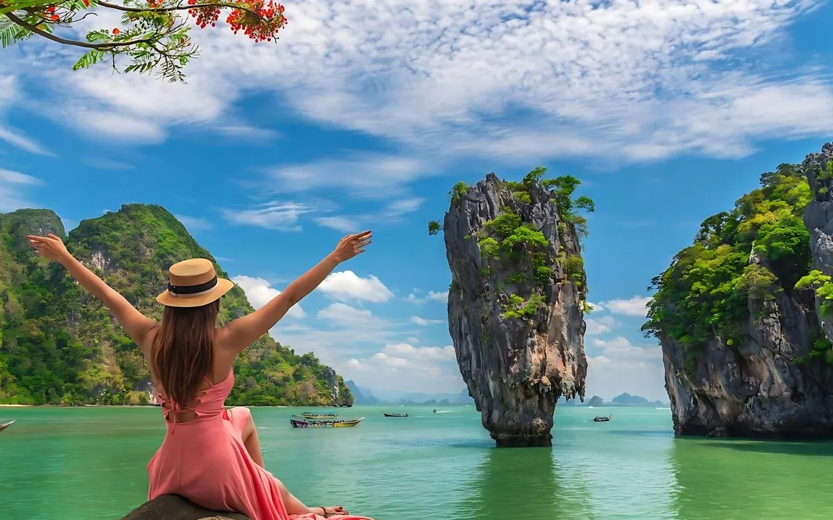 A sea canoe entering a limestone cave in Phang Nga Bay