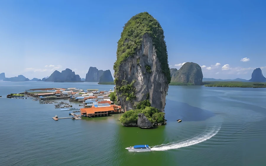 A sea canoe under the overhang of a limestone island