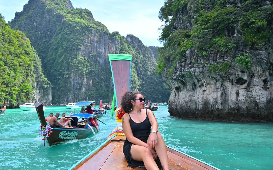 A private speedboat at anchor in clear water off a limestone island