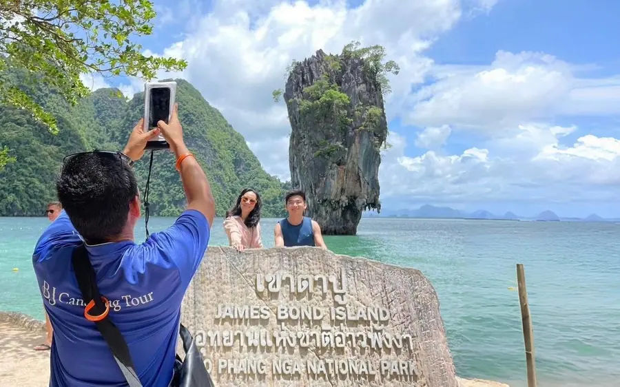 A speedboat anchored below the cliffs of Phang Nga Bay